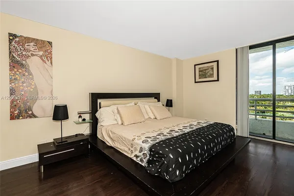 a bedroom with a bed window and wooden floor