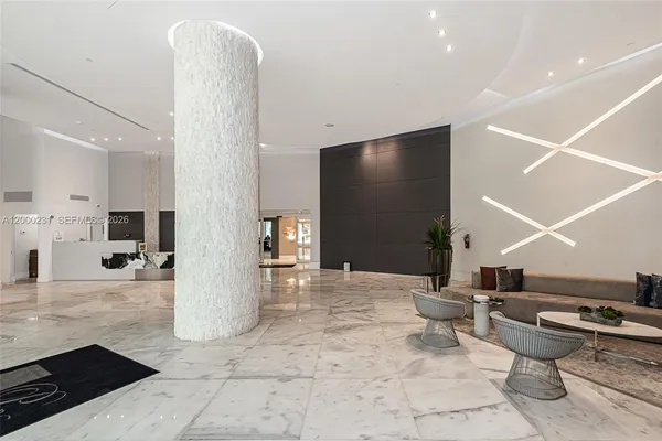 a lobby with furniture and a flat screen tv