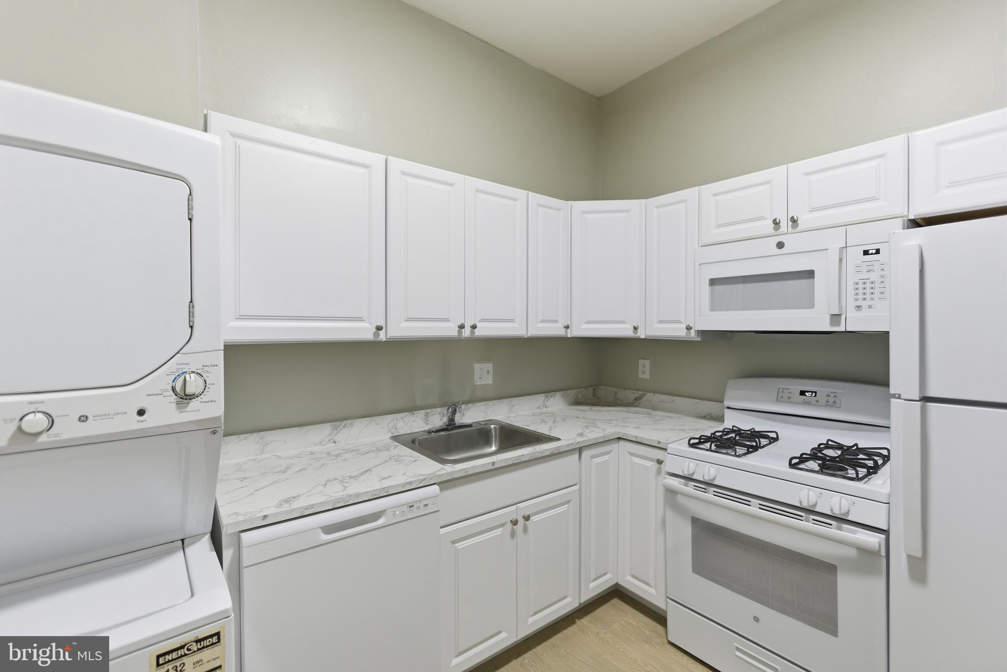 18806 Walkers Choice Road, Unit 2 Montgomery Village, MD 20886 - Photo 12 of 18 a kitchen with cabinets appliances and a counter space