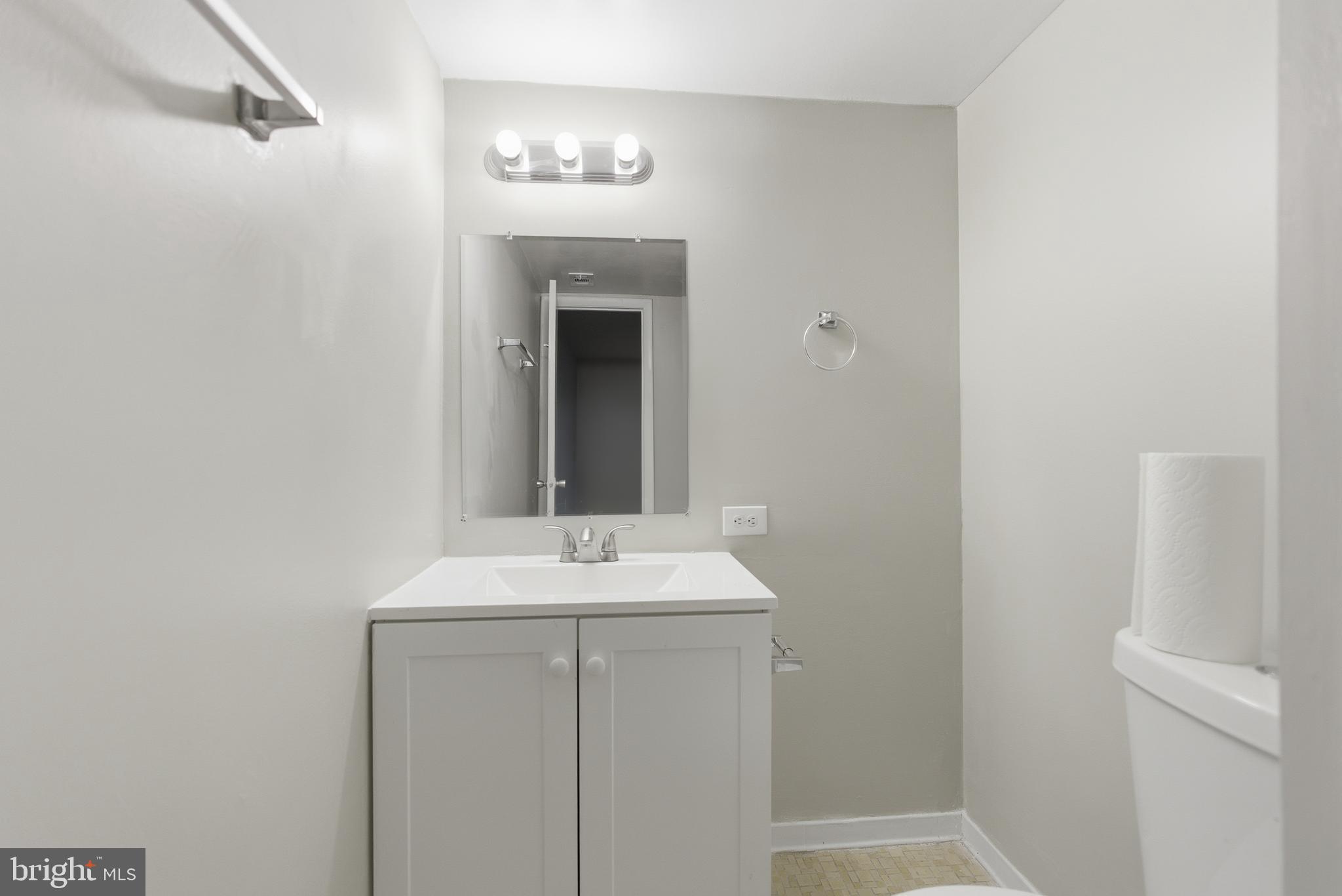 18806 Walkers Choice Road, Unit 2 Montgomery Village, MD 20886 - Photo 14 of 18 a bathroom with a sink and a mirror