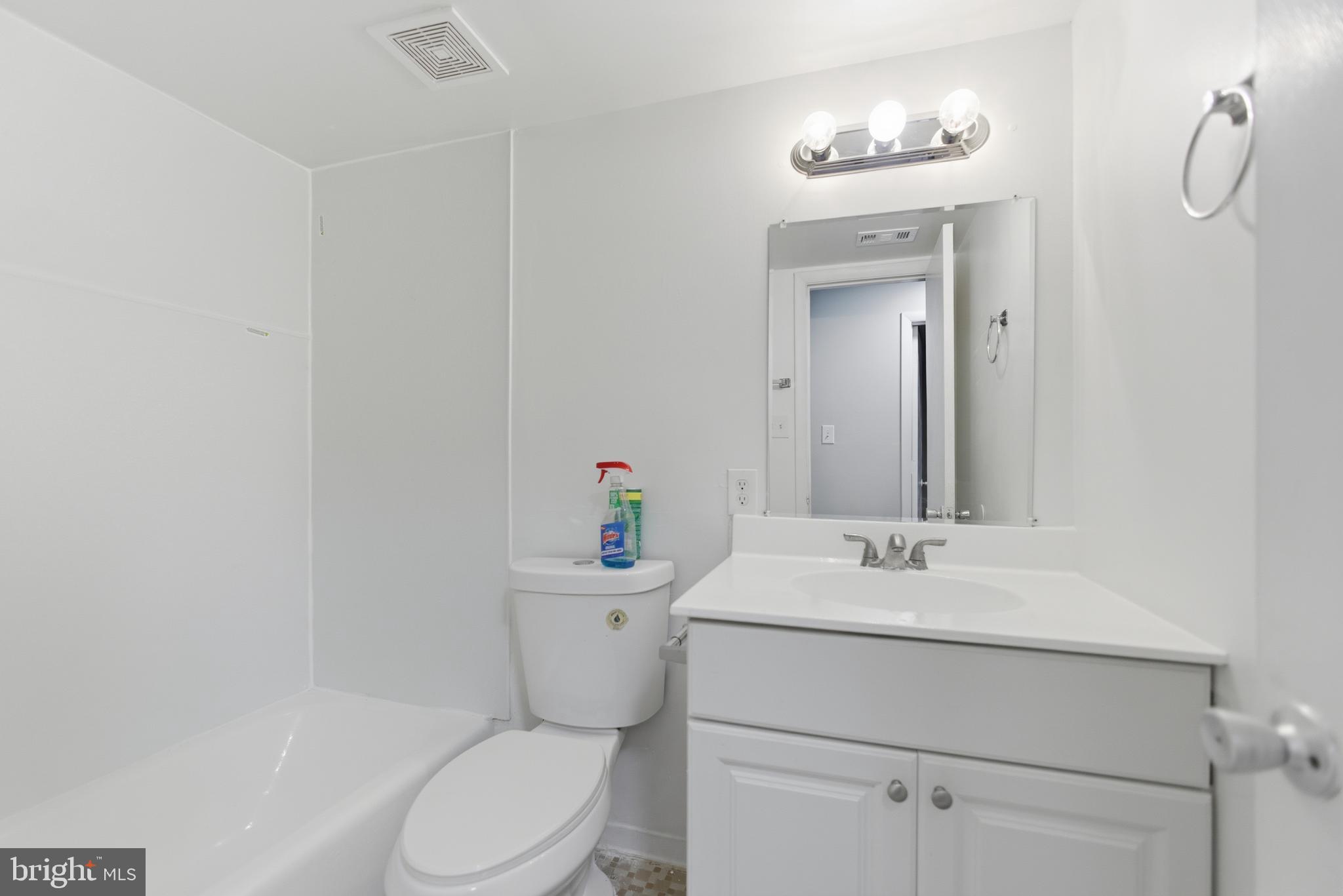 18806 Walkers Choice Road, Unit 2 Montgomery Village, MD 20886 - Photo 15 of 18 a bathroom with a sink vanity mirror and toilet