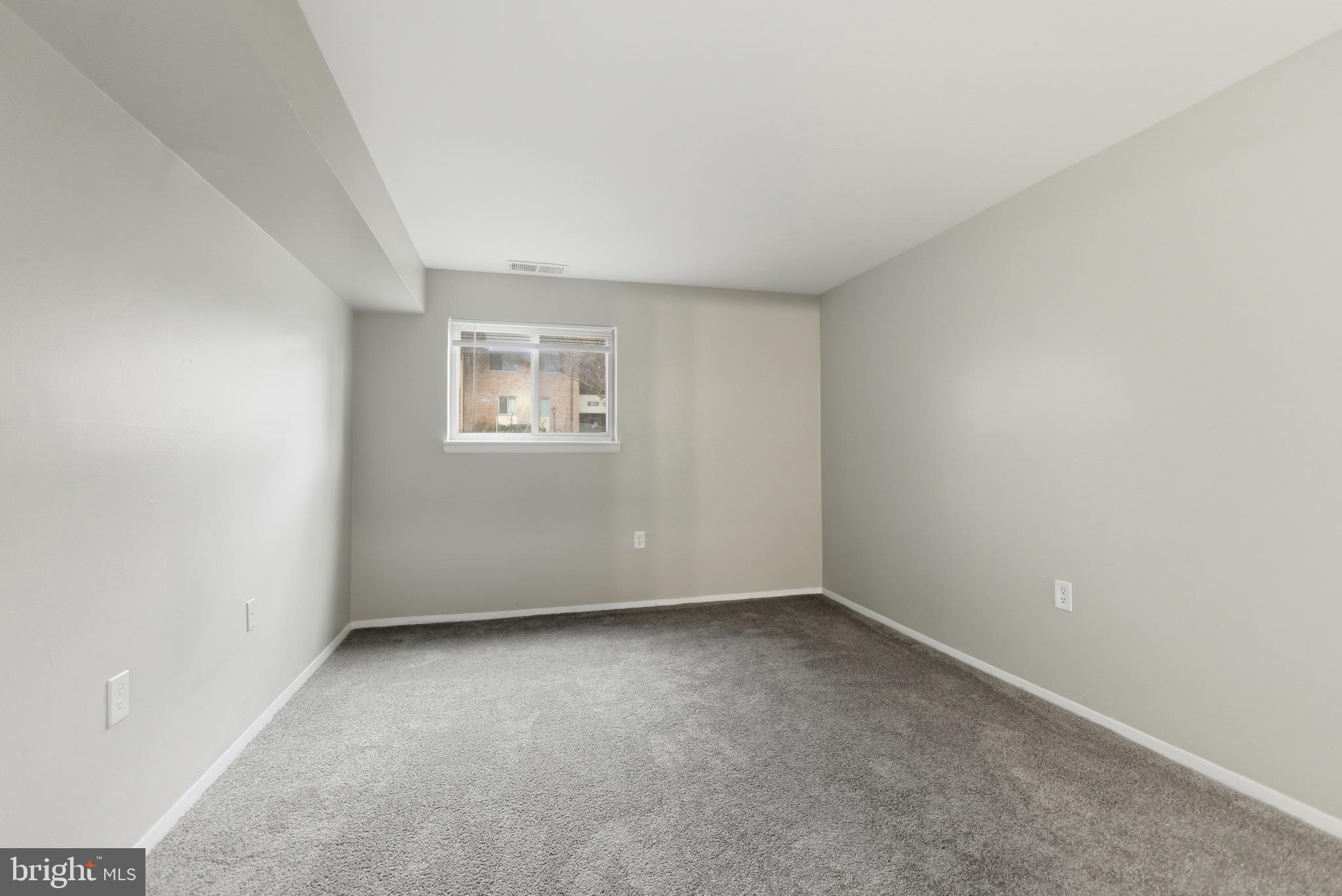 18806 Walkers Choice Road, Unit 2 Montgomery Village, MD 20886 - Photo 17 of 18 an empty room with a window