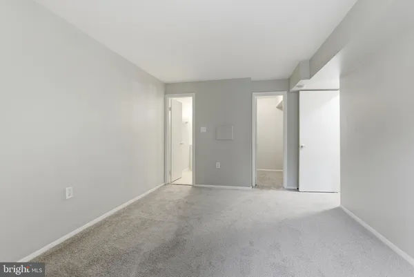 a view of an empty room and closet area