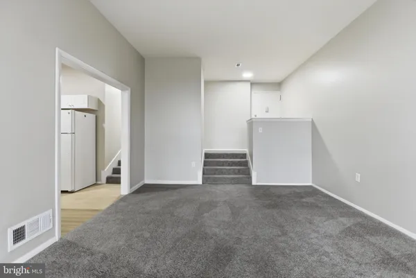 a view of a hallway with closet and wooden floor