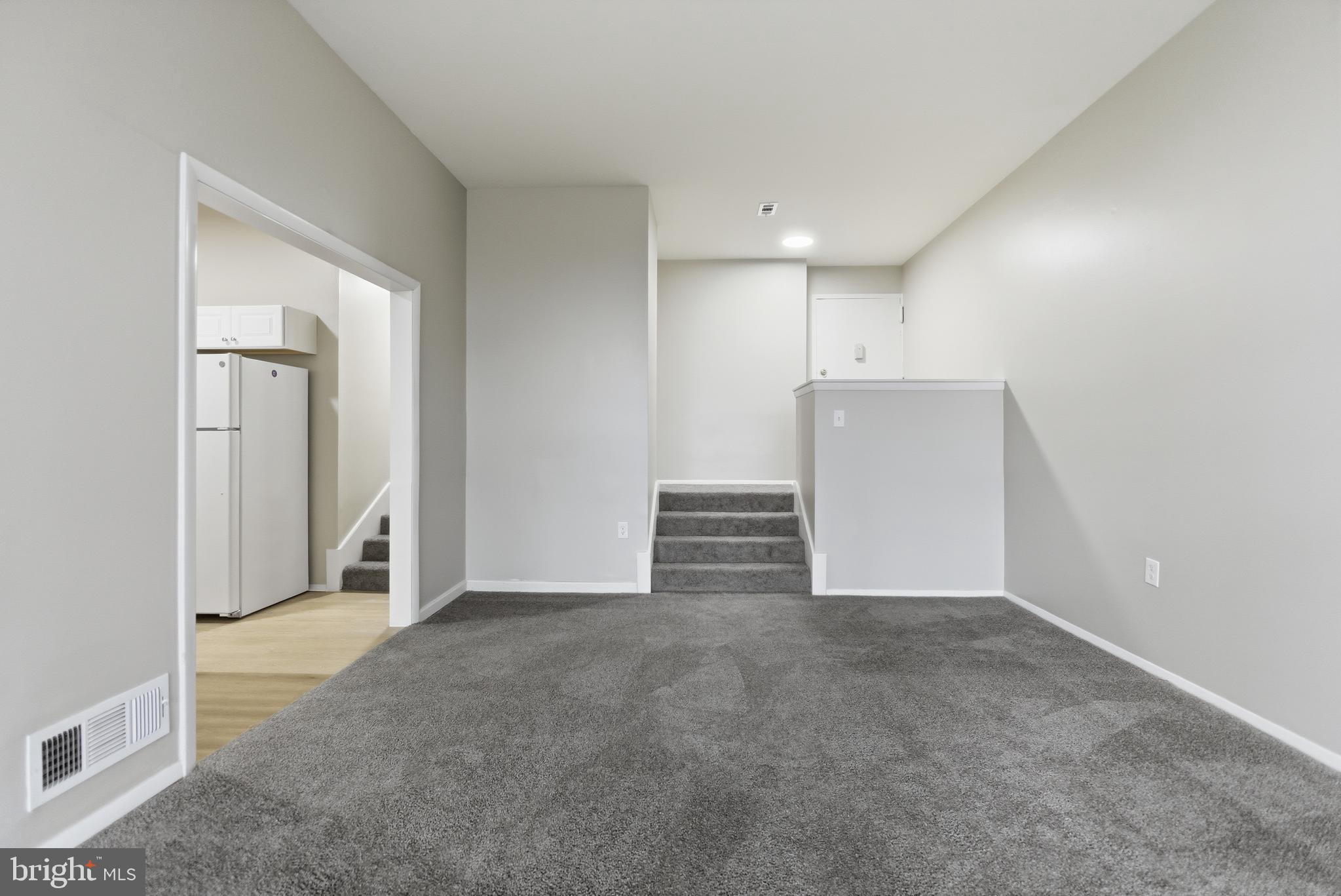 18806 Walkers Choice Road, Unit 2 Montgomery Village, MD 20886 - Photo 8 of 18 an empty room with kitchen and windows