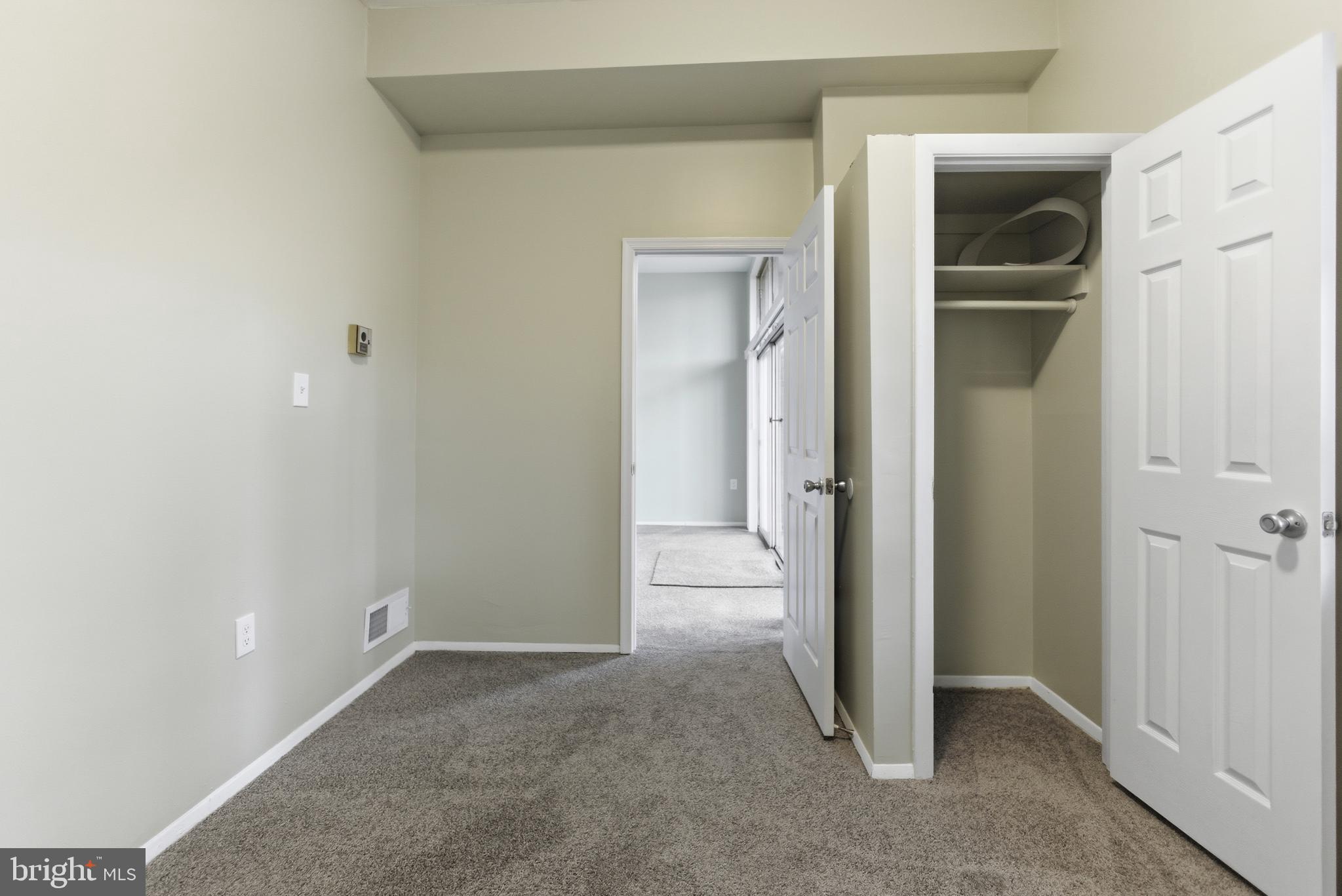 18806 Walkers Choice Road, Unit 2 Montgomery Village, MD 20886 - Photo 9 of 18 a view of a hallway with closet and wooden floor