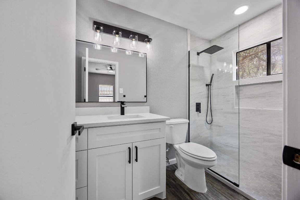 4711 Spicewood Springs Road, Unit 106 Austin, TX 78759 - Photo 12 of 23 a bathroom with a toilet sink shower and mirror