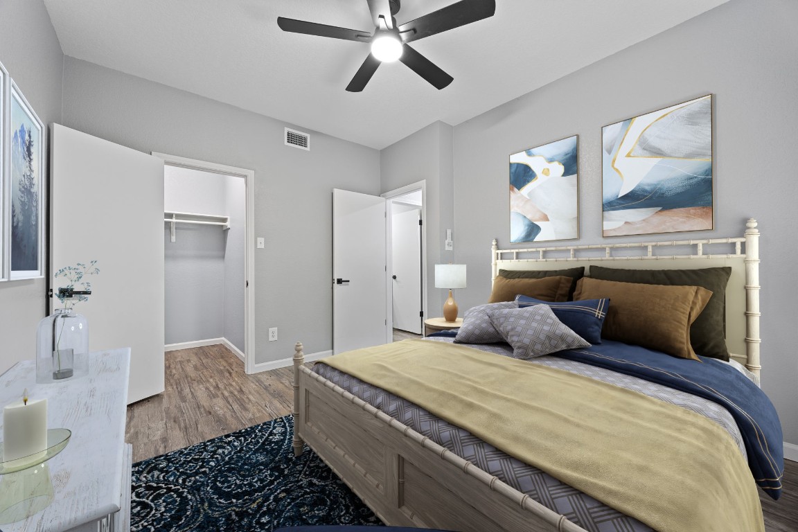 4711 Spicewood Springs Road, Unit 106 Austin, TX 78759 - Photo 14 of 23 a bedroom with a large bed and a chandelier