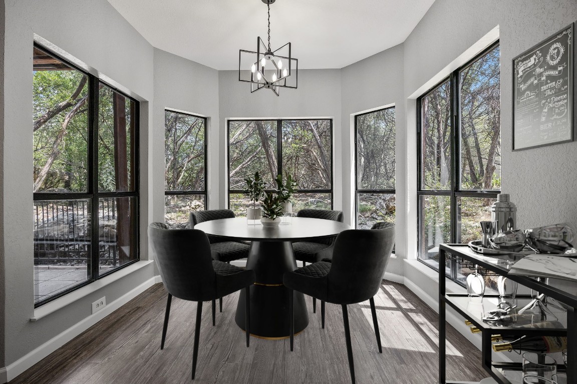 4711 Spicewood Springs Road, Unit 106 Austin, TX 78759 - Photo 6 of 23 a view of a dining room with furniture large windows and wooden floor