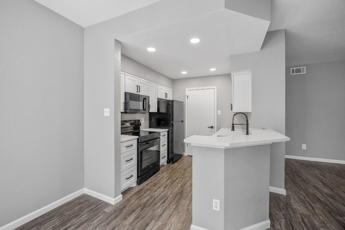 4711 Spicewood Springs Road, Unit 106 Austin, TX 78759 - Photo 8 of 23 a kitchen with stainless steel appliances granite countertop a sink stove and refrigerator