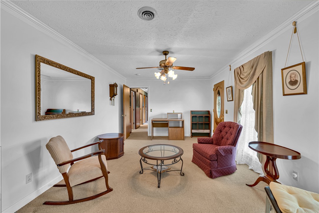 307 Calhoun Road Belton, SC 29627 - Photo 13 of 30 A classic interior space features textured ceilings and warm carpeted flooring.