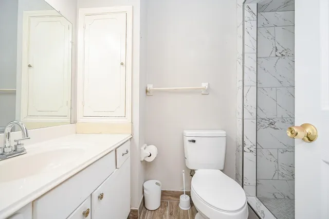 a bathroom with a sink a toilet and shower