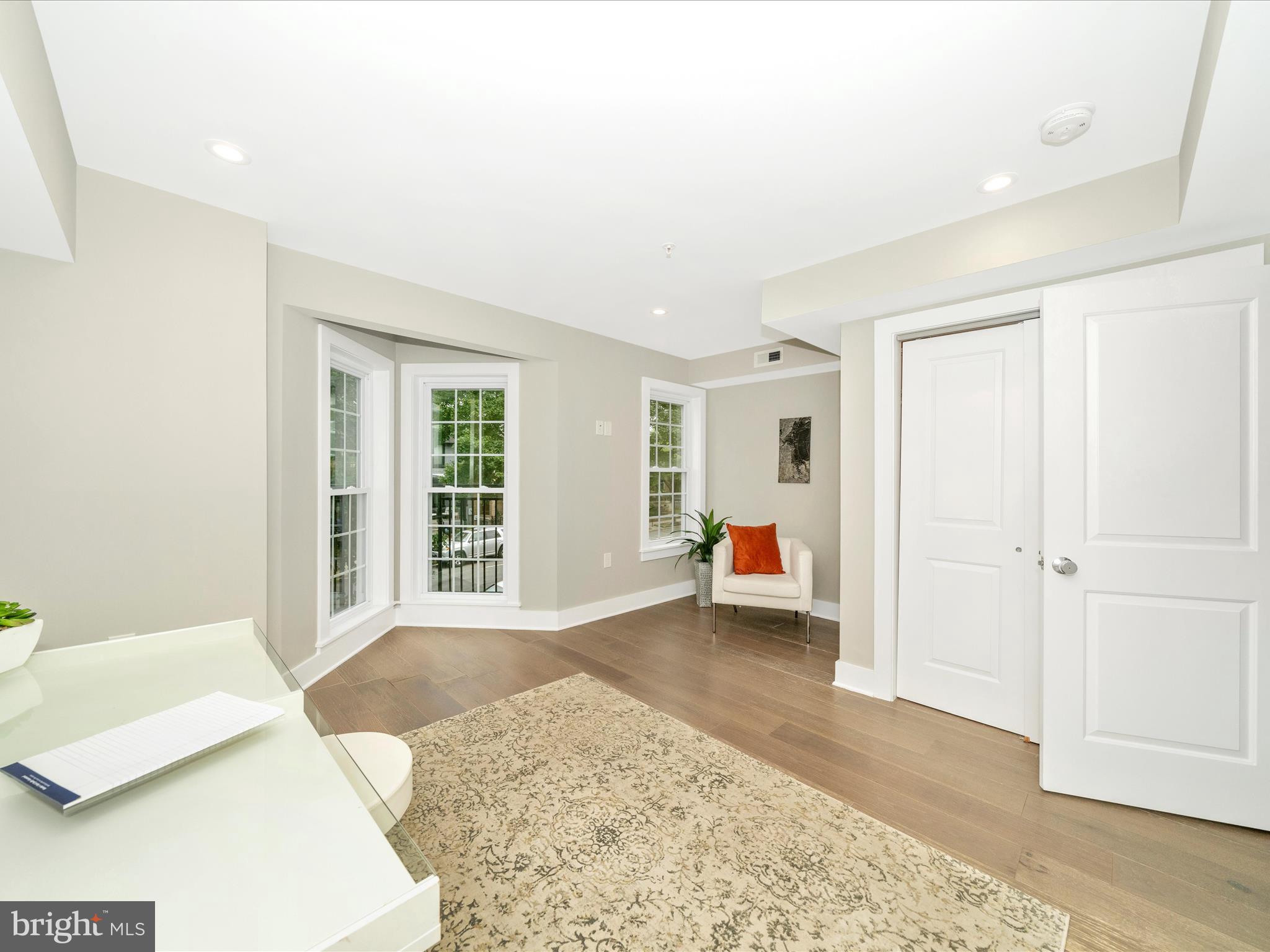 1826 Independence Avenue Southeast, Unit 4 Washington, DC 20003 - Photo 13 of 53 a view of a bedroom with a bed and wooden floor