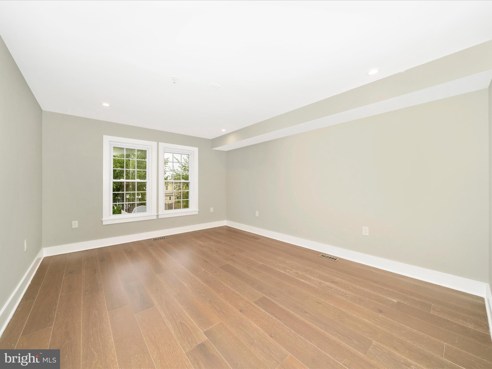 1826 Independence Avenue Southeast, Unit 4 Washington, DC 20003 - Photo 43 of 53 an empty room with wooden floor and windows