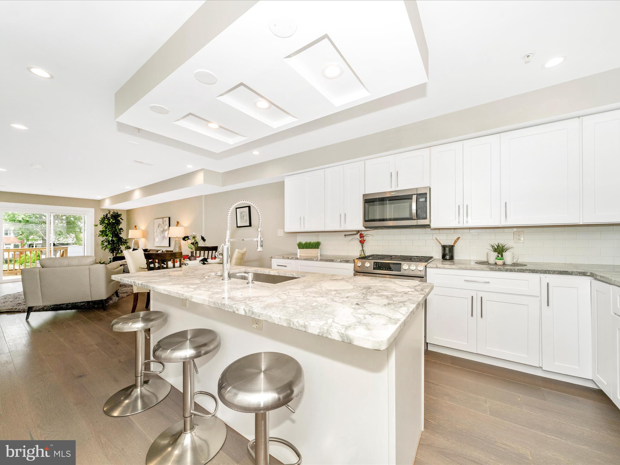 1826 Independence Avenue Southeast, Unit 4 Washington, DC 20003 - Photo 5 of 53 a kitchen with stainless steel appliances granite countertop a stove a sink dishwasher a stove a refrigerator with a dining table and chairs
