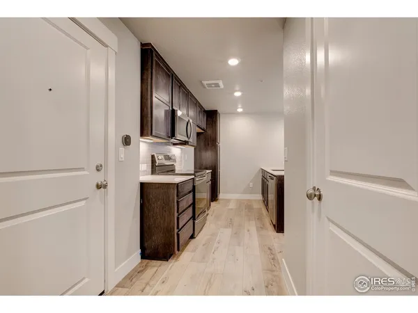 a view of kitchen with stainless steel appliances cabinets