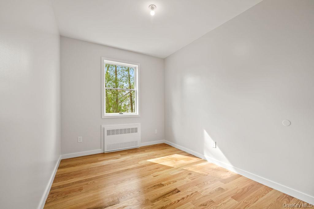 5 Mirror Lake Road, Unit 202 Spring Valley, NY 10977 - Photo 41 of 50 a view of an empty room with wooden floor and a window