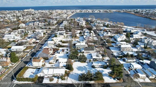 a front view of a house with yard covered in snow