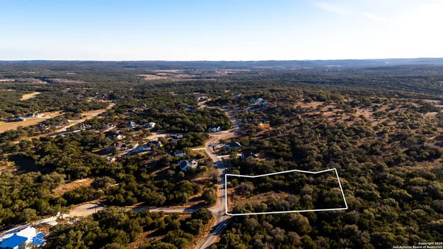 an aerial view of residential houses with city view