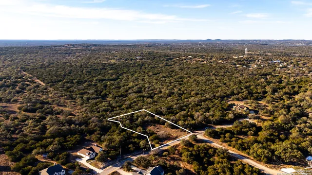 an aerial view of residential houses with city view