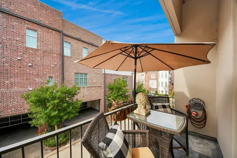 a view of deck with furniture and barbeque oven in the backyard