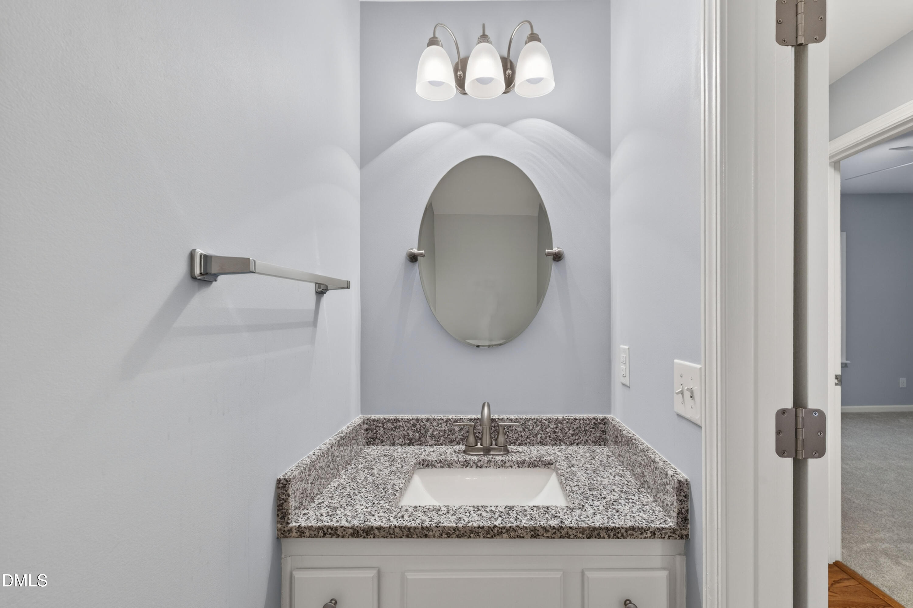 5421 Golden Arrow Lane Raleigh, NC 27613 - Photo 9 of 49 a bathroom with a granite countertop sink and a mirror