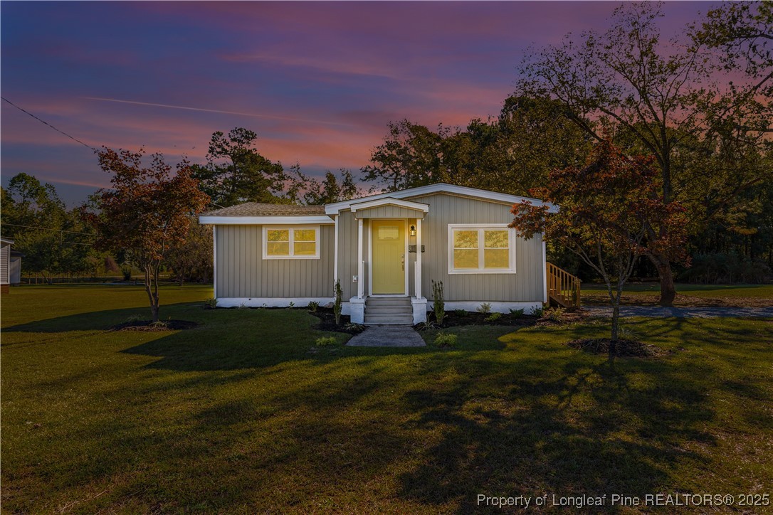 1340 George Perry Lee Road Dunn, NC 28334 - Photo 2 of 31 a view of a house with a yard