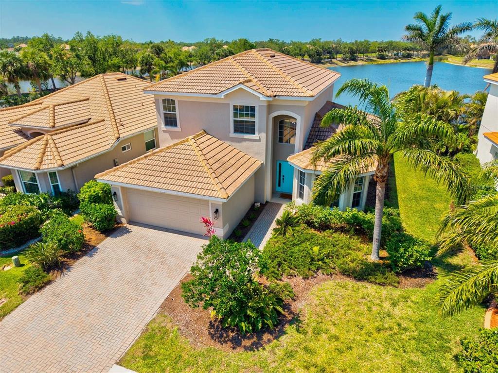 a aerial view of a house with a yard and potted plants