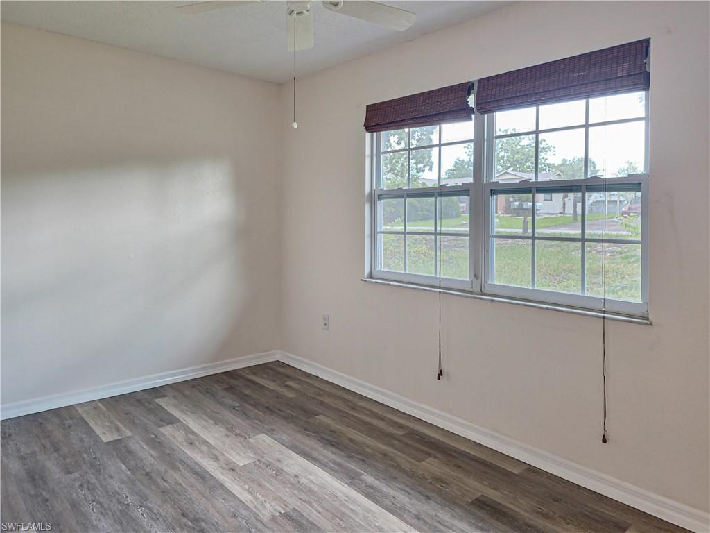 7425 Galloway Road Weeki Wachee, FL 34613 - Photo 11 of 23 wooden floor in an empty room with a window