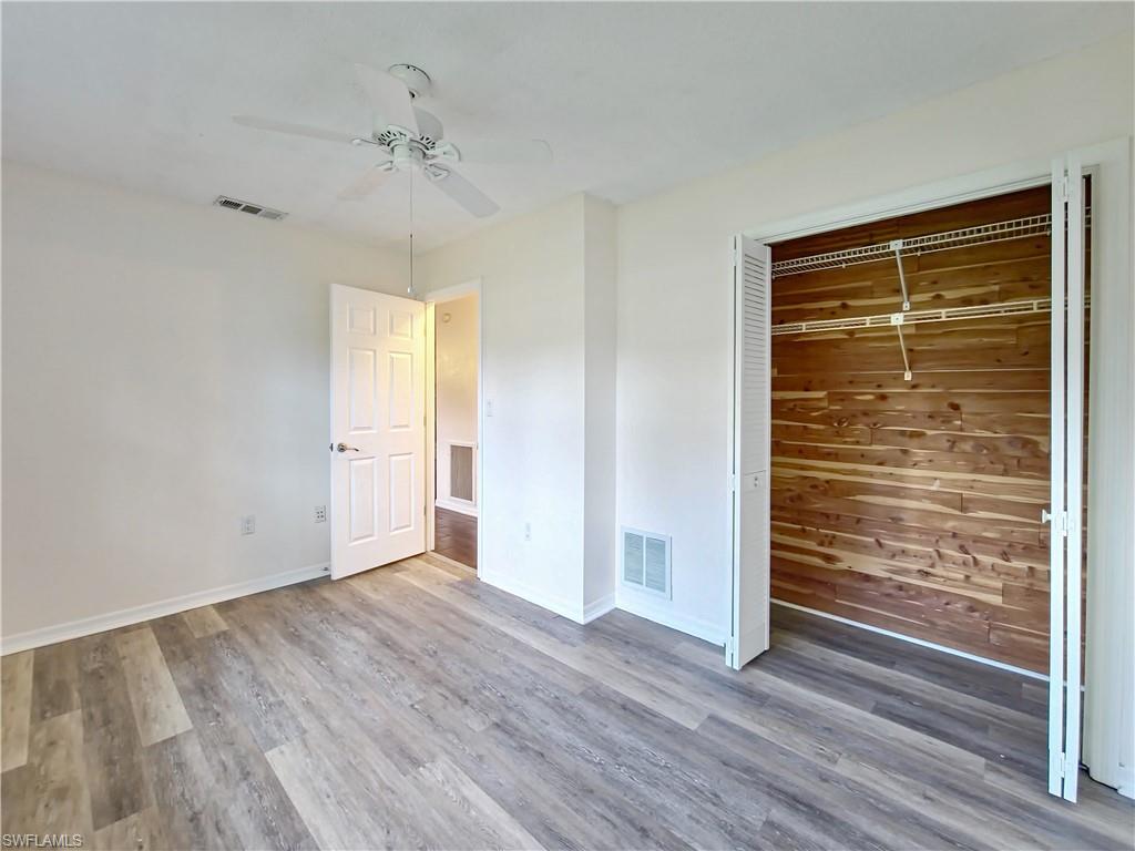 7425 Galloway Road Weeki Wachee, FL 34613 - Photo 12 of 23 a view of an empty room with wooden floor and a window