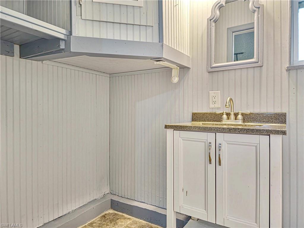 7425 Galloway Road Weeki Wachee, FL 34613 - Photo 13 of 23 a bathroom with a granite countertop sink and a mirror