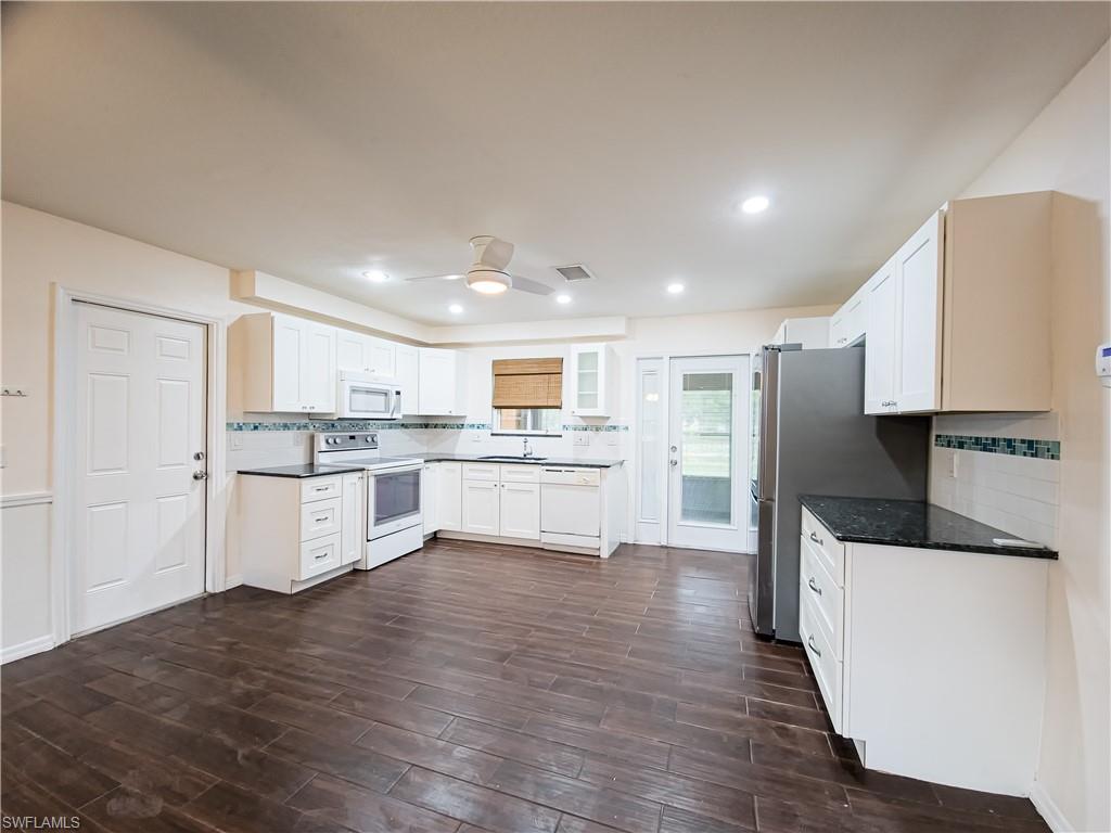 7425 Galloway Road Weeki Wachee, FL 34613 - Photo 3 of 23 a large kitchen with a center island and stainless steel appliances
