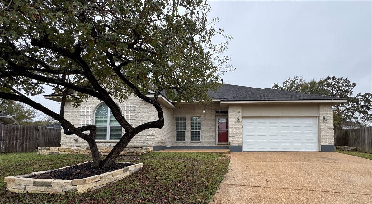 1502 Bluefield Court College Station, TX 77845 - Photo 1 of 26 a front view of a house with garden