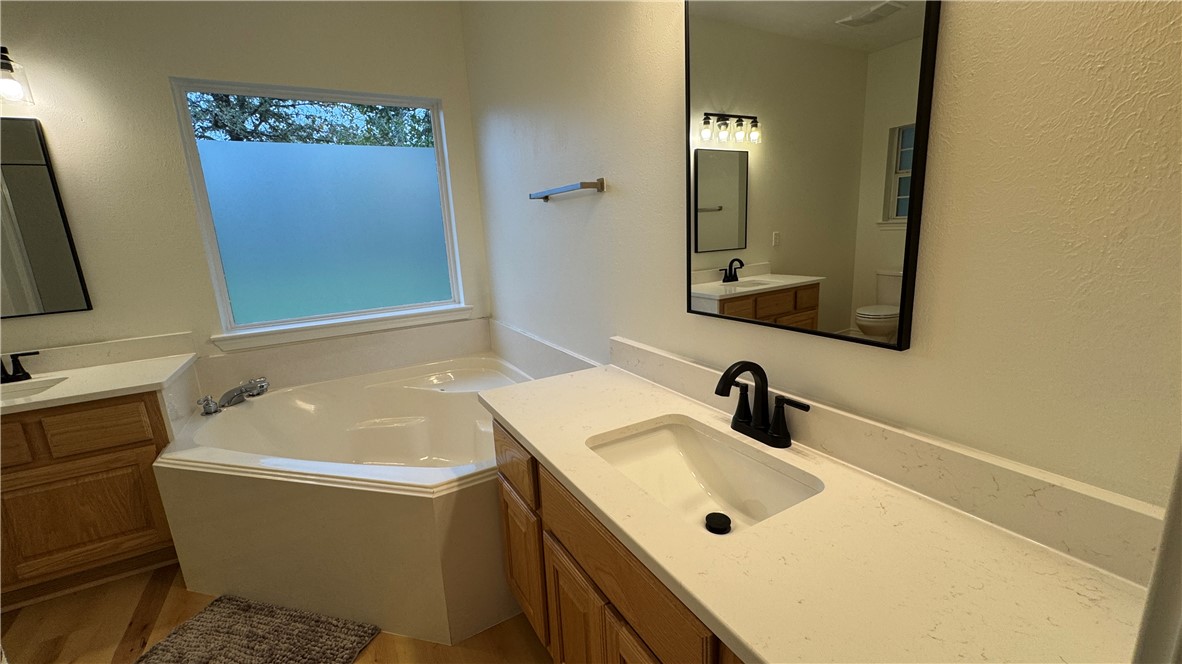 1502 Bluefield Court College Station, TX 77845 - Photo 12 of 26 a bathroom with a tub sink and mirror