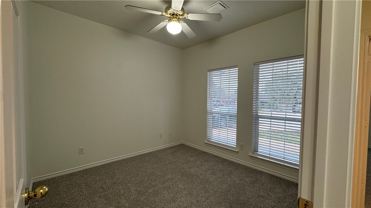 1502 Bluefield Court College Station, TX 77845 - Photo 14 of 26 an empty room with a ceiling fan and window