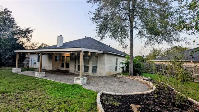 a backyard of a house with table and chairs
