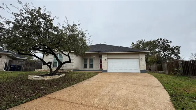 a front view of a house with a yard and a garage