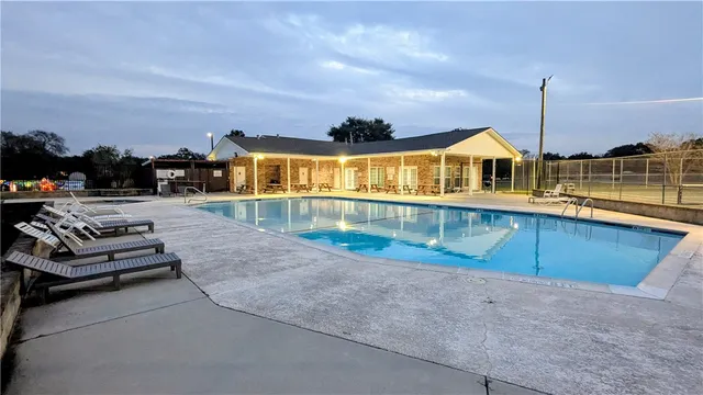 a view of a house with roof deck and seating space