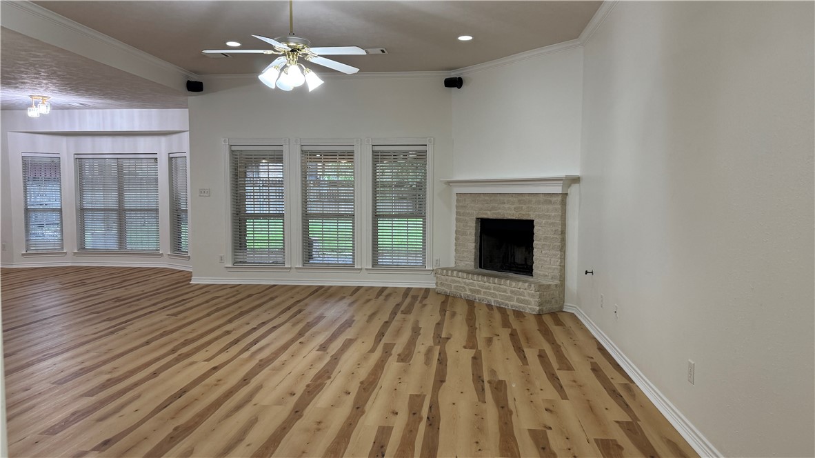 1502 Bluefield Court College Station, TX 77845 - Photo 4 of 26 a view of an empty room with wooden floor fireplace and a window