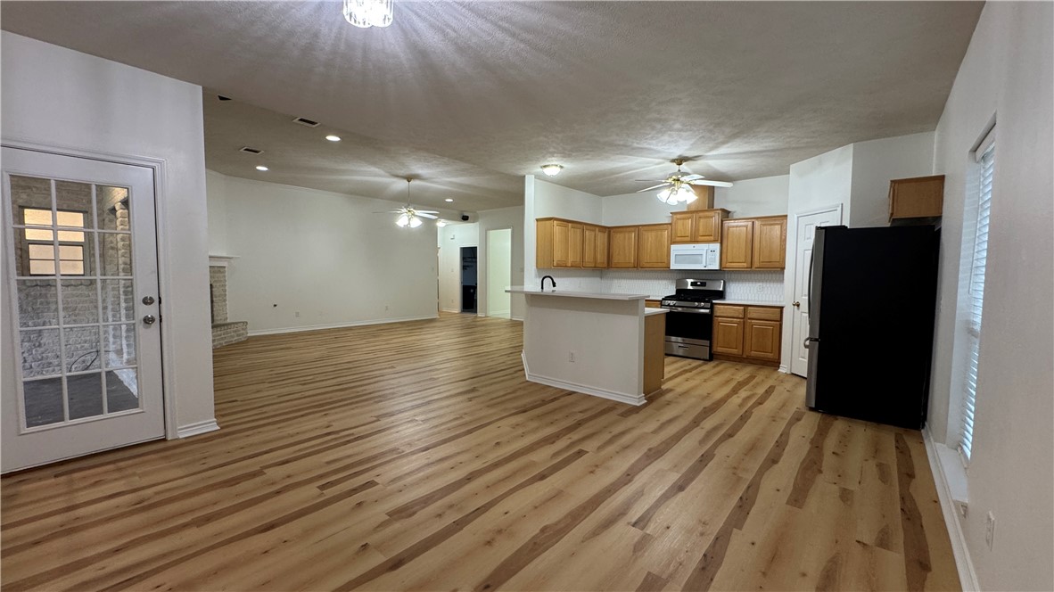 1502 Bluefield Court College Station, TX 77845 - Photo 26 of 26 a kitchen with a refrigerator and a stove top oven