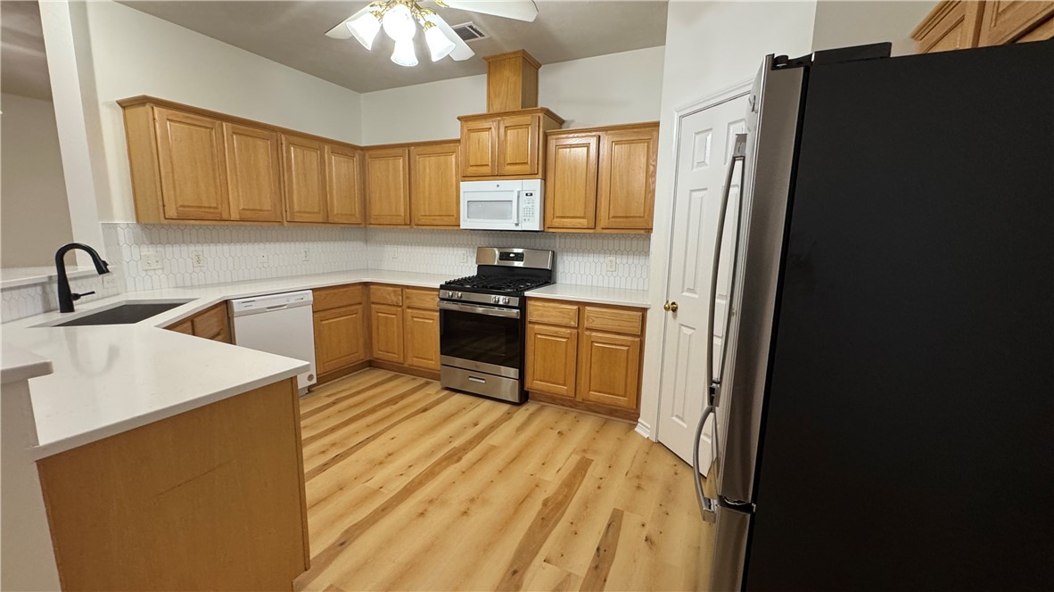 1502 Bluefield Court College Station, TX 77845 - Photo 7 of 26 a kitchen with a sink appliances and cabinets