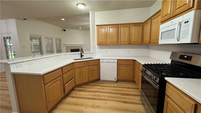 a kitchen with a sink appliances and cabinets