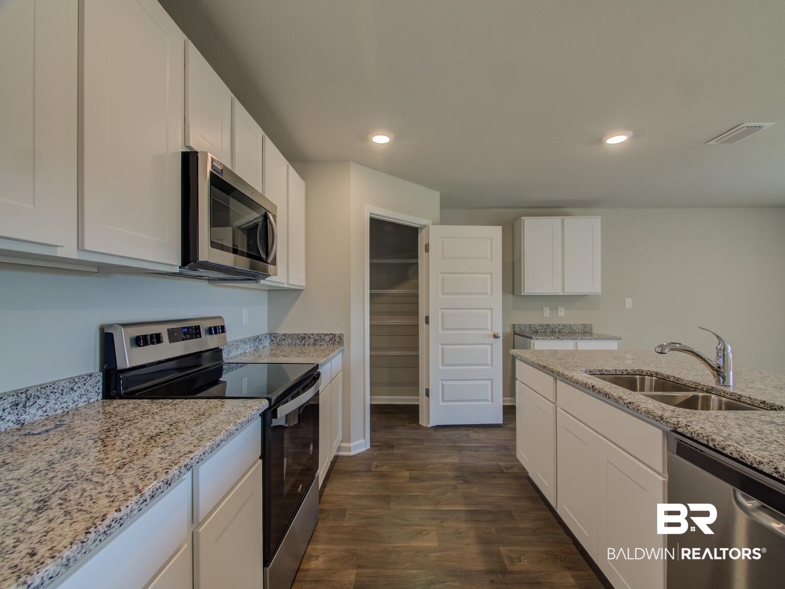 23953 Citation Loop Daphne, AL 36526 - Photo 14 of 49 Kitchen featuring stainless steel appliances, dark wood-style flooring, light stone counters, recessed lighting, and white cabinets