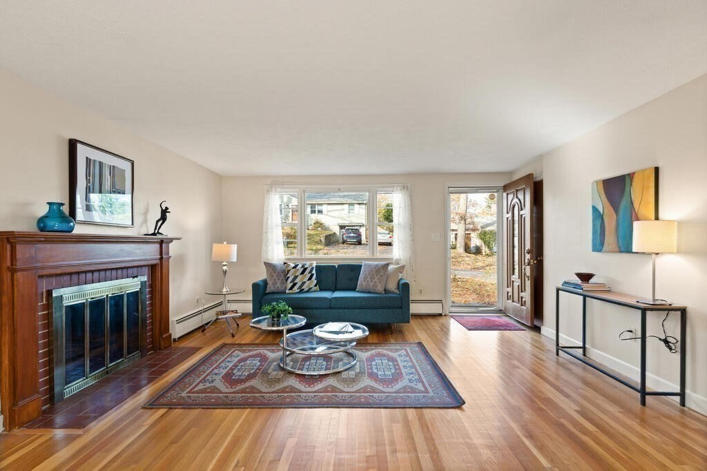 14 Tarbell Avenue Lexington, MA 02421 - Photo 1 of 30 a living room with furniture and a fireplace