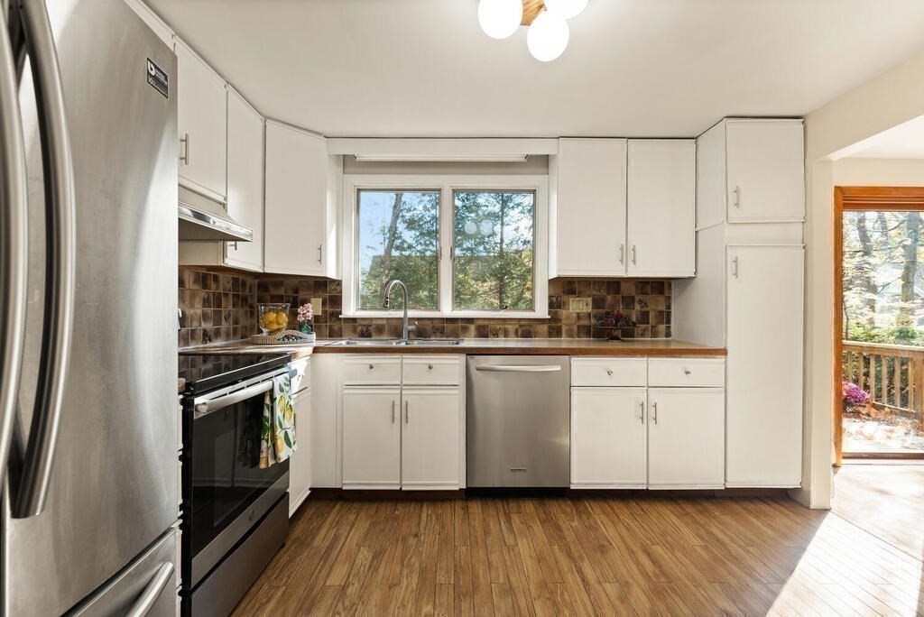 14 Tarbell Avenue Lexington, MA 02421 - Photo 11 of 30 a kitchen with cabinets stainless steel appliances a sink and a window