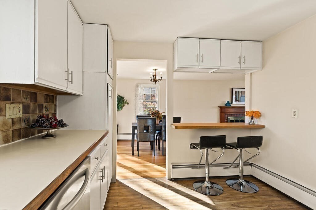 14 Tarbell Avenue Lexington, MA 02421 - Photo 12 of 30 a kitchen with stainless steel appliances a table and chairs in it