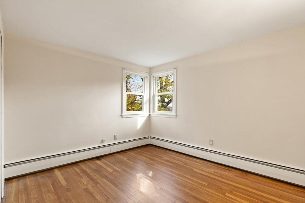 14 Tarbell Avenue Lexington, MA 02421 - Photo 16 of 30 an empty room with wooden floor and windows
