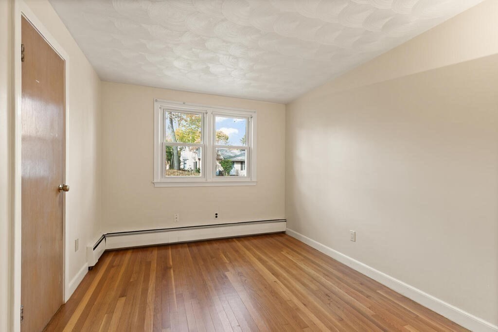 14 Tarbell Avenue Lexington, MA 02421 - Photo 17 of 30 wooden floor in an empty room with a window