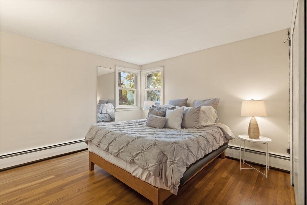 14 Tarbell Avenue Lexington, MA 02421 - Photo 18 of 30 a bedroom with a bed and wooden floor
