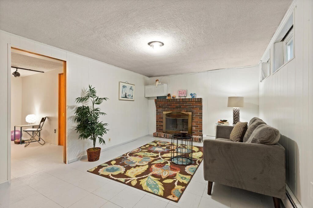 14 Tarbell Avenue Lexington, MA 02421 - Photo 20 of 30 a living room with furniture and a fireplace